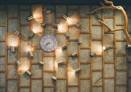 Living room interior with clock and branch on green wall with light backgroundの写真素材