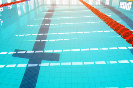 Track & lanes of a competition swimming pool.
Indoor swimming pool with empty lanes.
