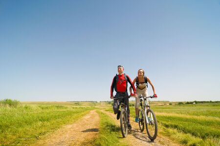 two cyclists relax biking outdoorsの写真素材