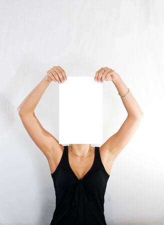 woman with blank paper instead of headの写真素材