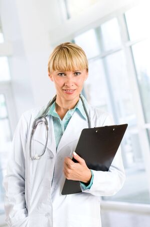 smiling medical doctor with stethoscopeの写真素材