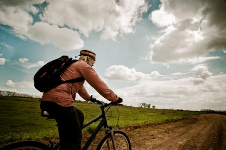 a girl relax biking at sunriseの写真素材