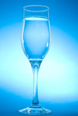 glass with water ob blue backgroundの写真素材