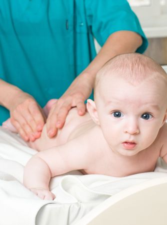 a doctor massaging little babyの写真素材