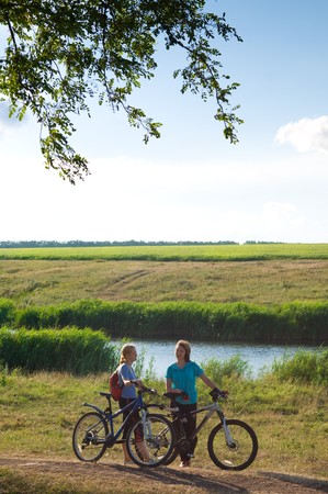 two cyclists relax biking outdoorsの写真素材