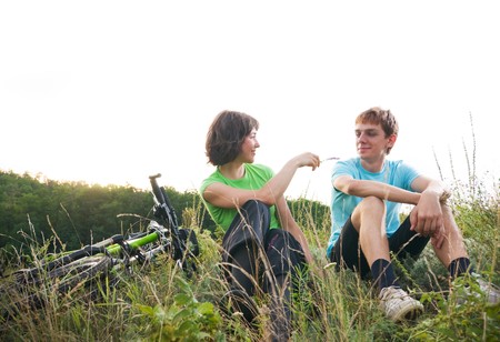 two cyclists relax biking outdoorsの写真素材