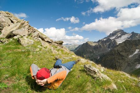 man hiking in mountain with binocularsの写真素材