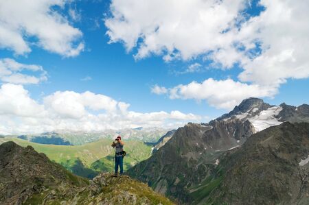 man hiking in mountain with binoculars