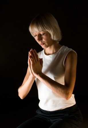 woman praying on black backgroundの写真素材