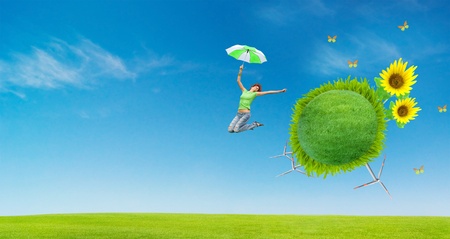 earth globe covered grass with jumping girlの写真素材