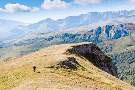 man hiking in mountain with backpackの写真素材