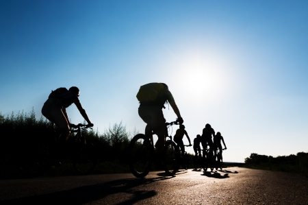group of cyclists biking in motionの写真素材