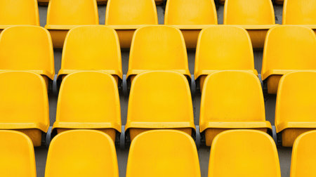 Rows of Bright Yellow Stadium Seats in a Modern Arena Creating a Vibrant and Energetic Atmosphere for Spectators and Fansの素材