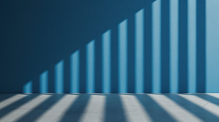 Blue Wall with Sharp Shadow Patterns Created by Sunlight Striking Through Vertical Slats in a Minimalist Indoor Spaceの素材