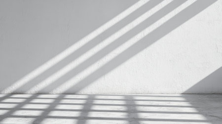 Minimalist Interior with Dramatic Shadows on White Wall and Floor Creating a Stunning Contrast and Inviting Ambiance for Art or Design Useの素材