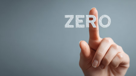 Hand Pointing at the Word Zero on a Gray Background Symbolizing Nothingness, Lack, or Minimalism in Conceptual Visualsの素材