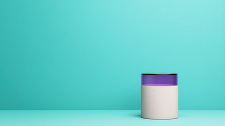 A minimalist container with a purple lid sits against a vibrant turquoise background, showcasing a modern and clean design.の素材
