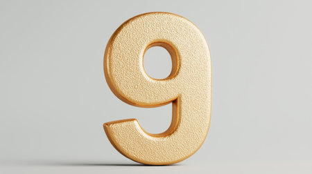 Detailed and Textured Golden Number Nine Against a Smooth Gray Background Ideal for Celebratory Artwork and Marketing Materialsの素材