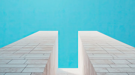 A minimalist view of two tall structures reaching toward a clear blue sky, showcasing modern architectural design and geometric shapes.の素材