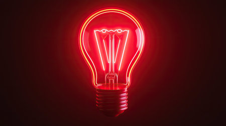 A glowing red light bulb illuminates against a dark background, showcasing a modern and vibrant design.の素材