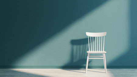 A minimalist white chair stands alone against a textured teal wall, illuminated by soft shadows, creating a serene and stylish atmosphere.の素材