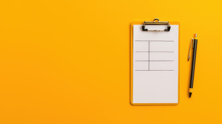 A clipboard with a checklist on bright orange background, portraying organization and task managementの素材
