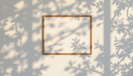blank poster frames on white wall with soft shadows of tree leaves, under radiant sunset orange glow, subject positioned at the top with ample copy space at the bottom.の素材