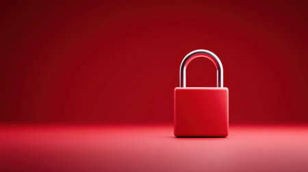 Bright red padlock centered on vibrant red background symbolizing security dramatic lighting casting soft shadows top-down angle.の素材