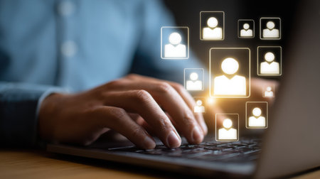 User engaging with online network platform showcasing digital silhouettes of people on a laptop, illustrating connections and community; modern technology conceptの素材