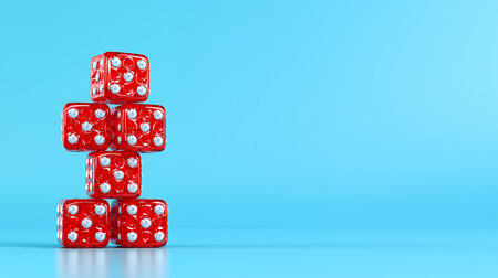 Stacked red dice against a blue background.の素材