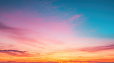 Fiery sunset sky with vibrant orange, pink, and purple hues, casting a warm glowing textureの素材