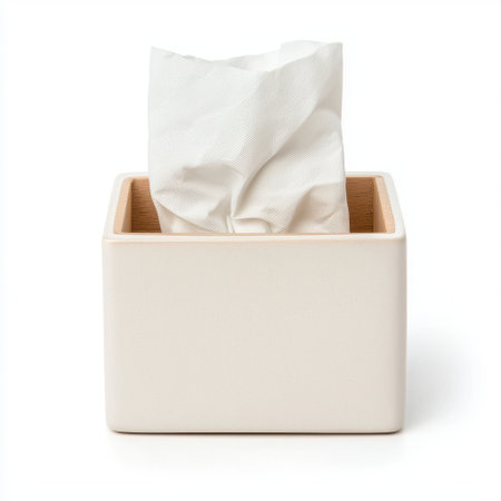 Elegant rectangular tissue box with a crumpled tissue peeking out, placed on a clean and minimalistic background, ideal for home or office decorの素材