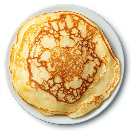 Golden Brown Pancake on White Plate with Unique Texture and Delicious Appeal for Breakfast or Brunch Imageryの素材