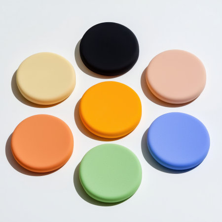 Colorful round silicone coasters arranged in a circular pattern on a bright background showcasing a variety of vibrant hues and soft textures for home decorの素材