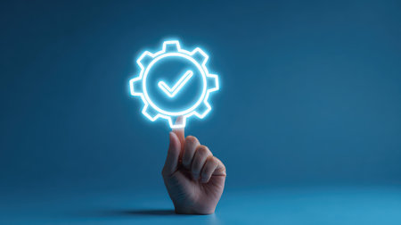 Hand Holding Neon Gear Icon with Checkmark Signifying Efficiency, Success, and Innovation in Creative Industry and Business Environmentsの素材