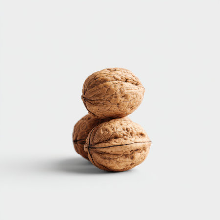Natural and Organic Walnuts Stacked Artistically on a White Background for Health and Nutrition Stock Photography Useの素材