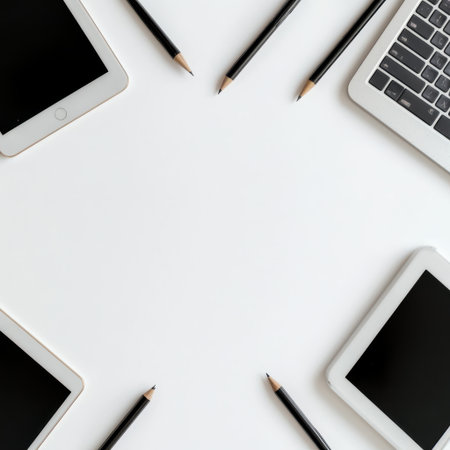 Modern Workspace Composition with Tablets, Laptop, Pencils, and Blank Screen for Creative and Business Use in Minimalist Styleの素材