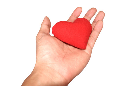 health medicine and charity concept  close up of male hands with small red heartの写真素材