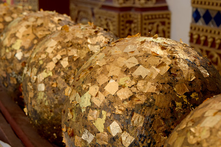 Golden round Loknimit at Thai temple. Golden paper stick on the Sphere for Thai traditionのeditorial素材