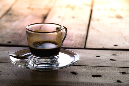 Close up coffee cup glass on wood tableの写真素材
