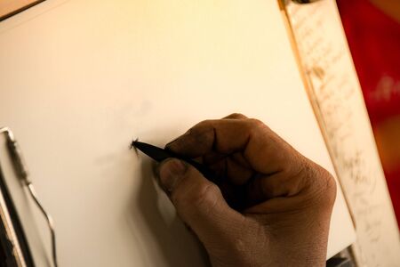 Close up hand hold pencil and sketch on paper artworkの写真素材