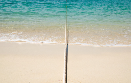 Anchor String rope from sea to beachの写真素材