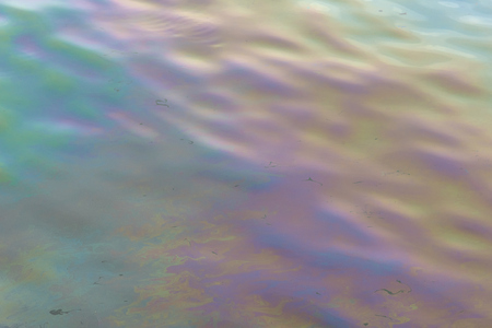Oil stains on the water surface abstract texture and backgroundの写真素材