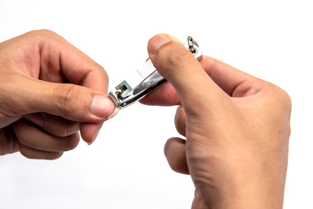 Man hand holding nail scissors to cut manicure.の写真素材