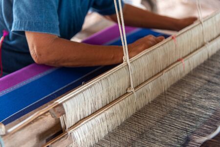 People are weaving with traditional Thai Lanna weaving machinesの写真素材