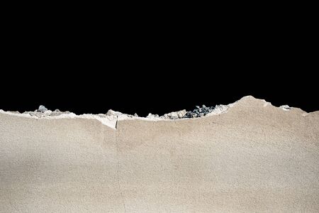 The wall of a cement that was smashed isolate on black backgroundの写真素材