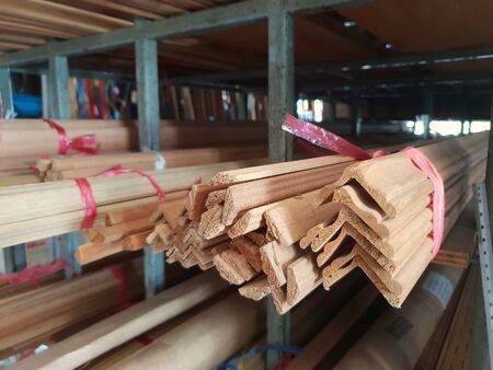 stack of  plywood wood in cut different shapes on a metal shelf in warehouseの写真素材