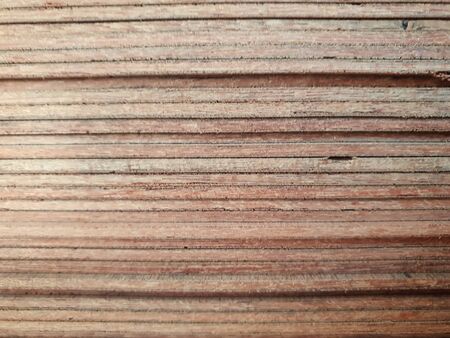 closeup on a side of stack pile of plywood wood cut and put on shelf in order abstract background textureの写真素材