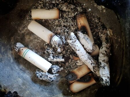 smoked cigarette butts in ashtrayの写真素材