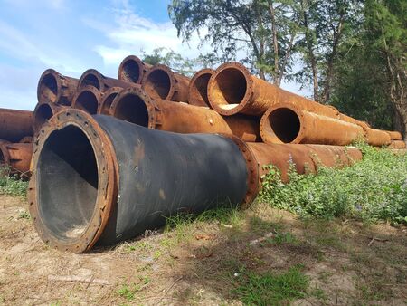 "Stack of abandoned rustic pipeline laid on the sand beach, underwater pipeline erosion for replacement in fuel business . toxic possible , "の写真素材